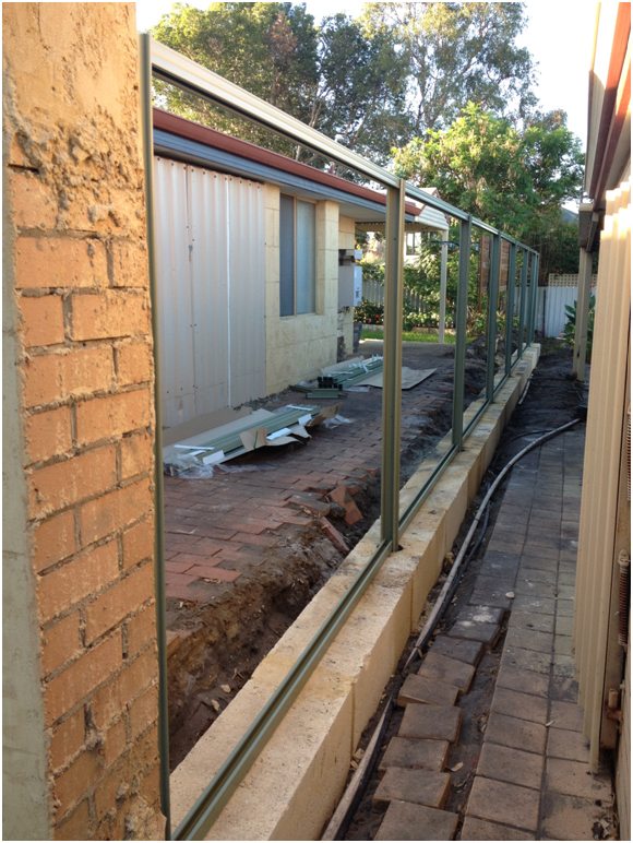 colorbond fencing installed onto limestone retaining blocks