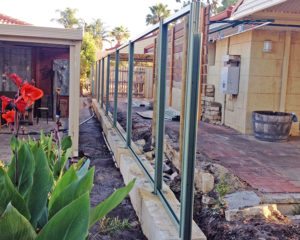 limestone block retaining with core drilled colorbond fence