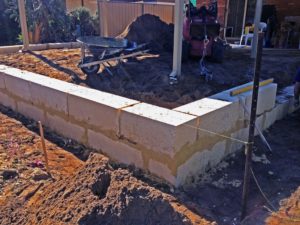 limestone block retaining wall under construction