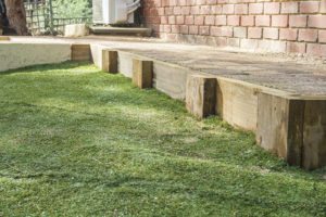 artificial grass against timber retaining