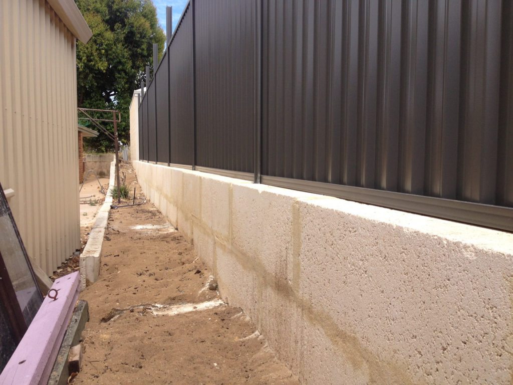 retaining wall with colorbond fence on top