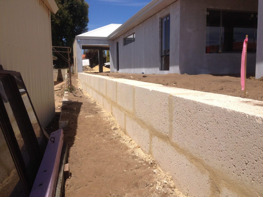 retaining wall with colorbond fence on top