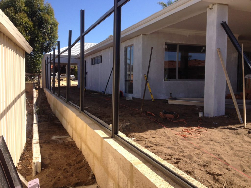 retaining wall with colorbond fence on top