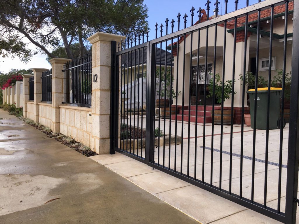 Reconstituted limestone block wall with infills Swanbourne and double gate