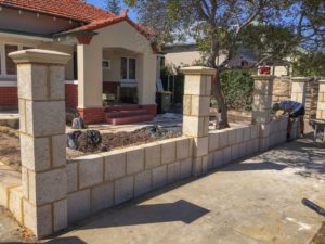 Reconstituted limestone block wall with infills Swanbourne before picture